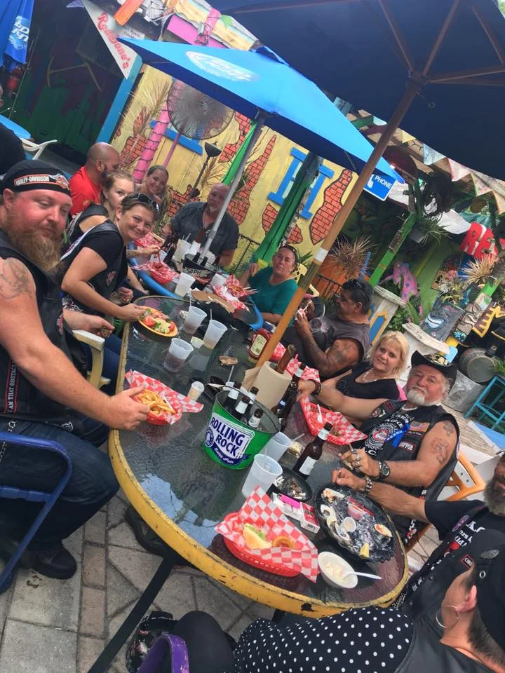 Group dining at a vibrant outdoor restaurant with colorful decor