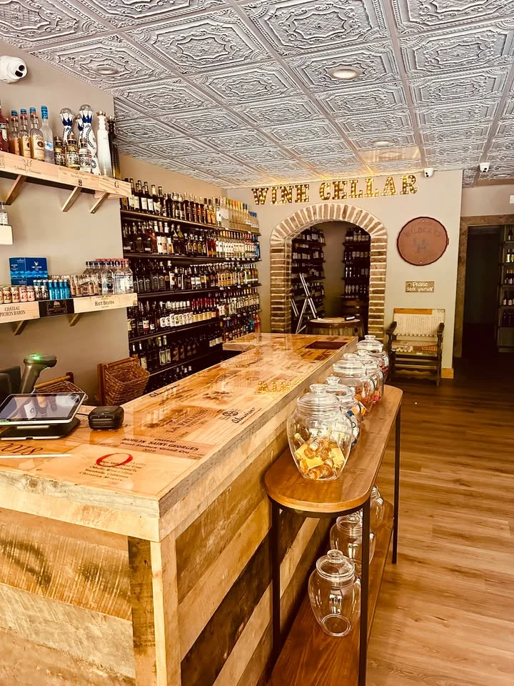 Cozy wine cellar interior with wooden bar and shelves of bottles