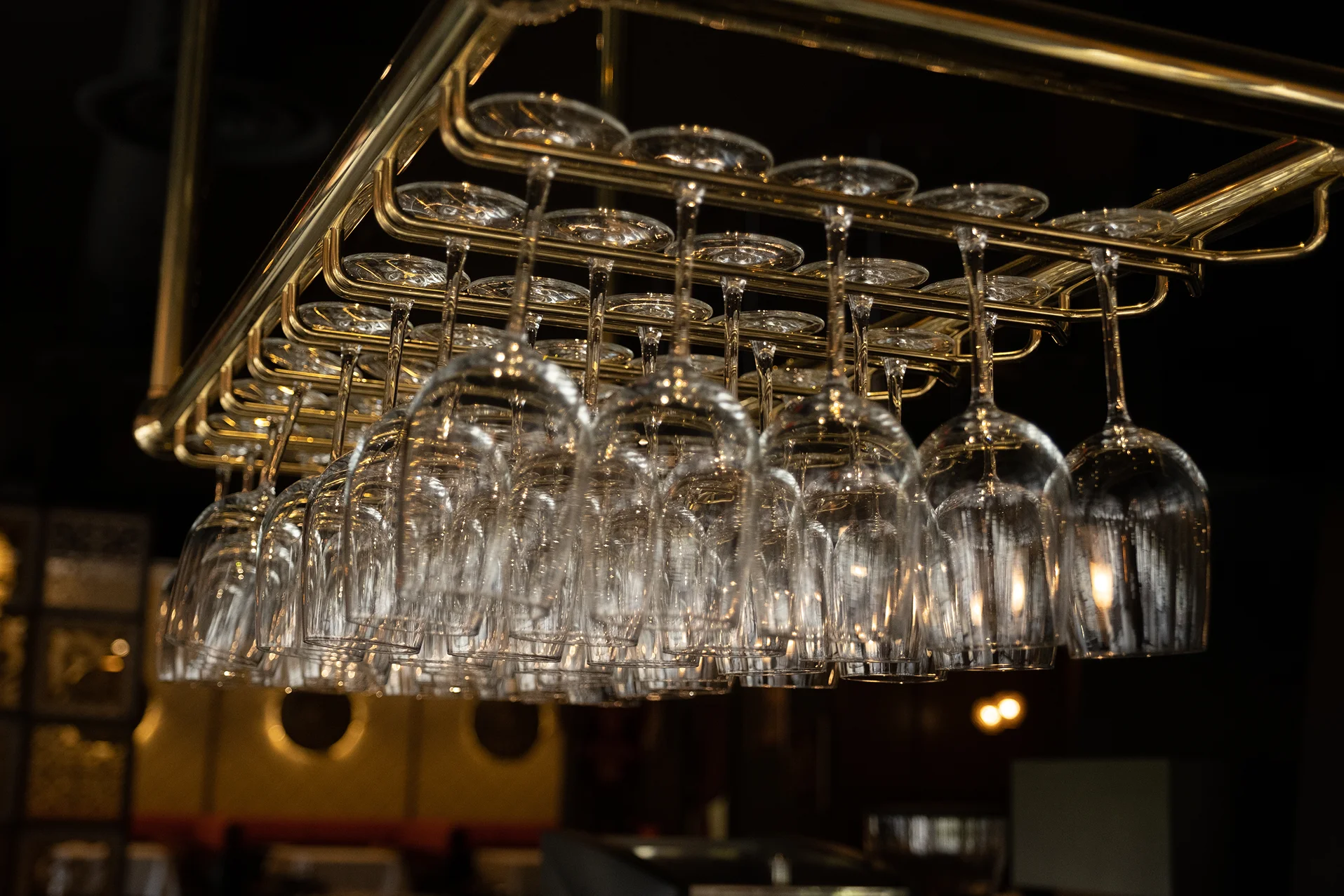 Elegant wine glasses hanging in a modern restaurant