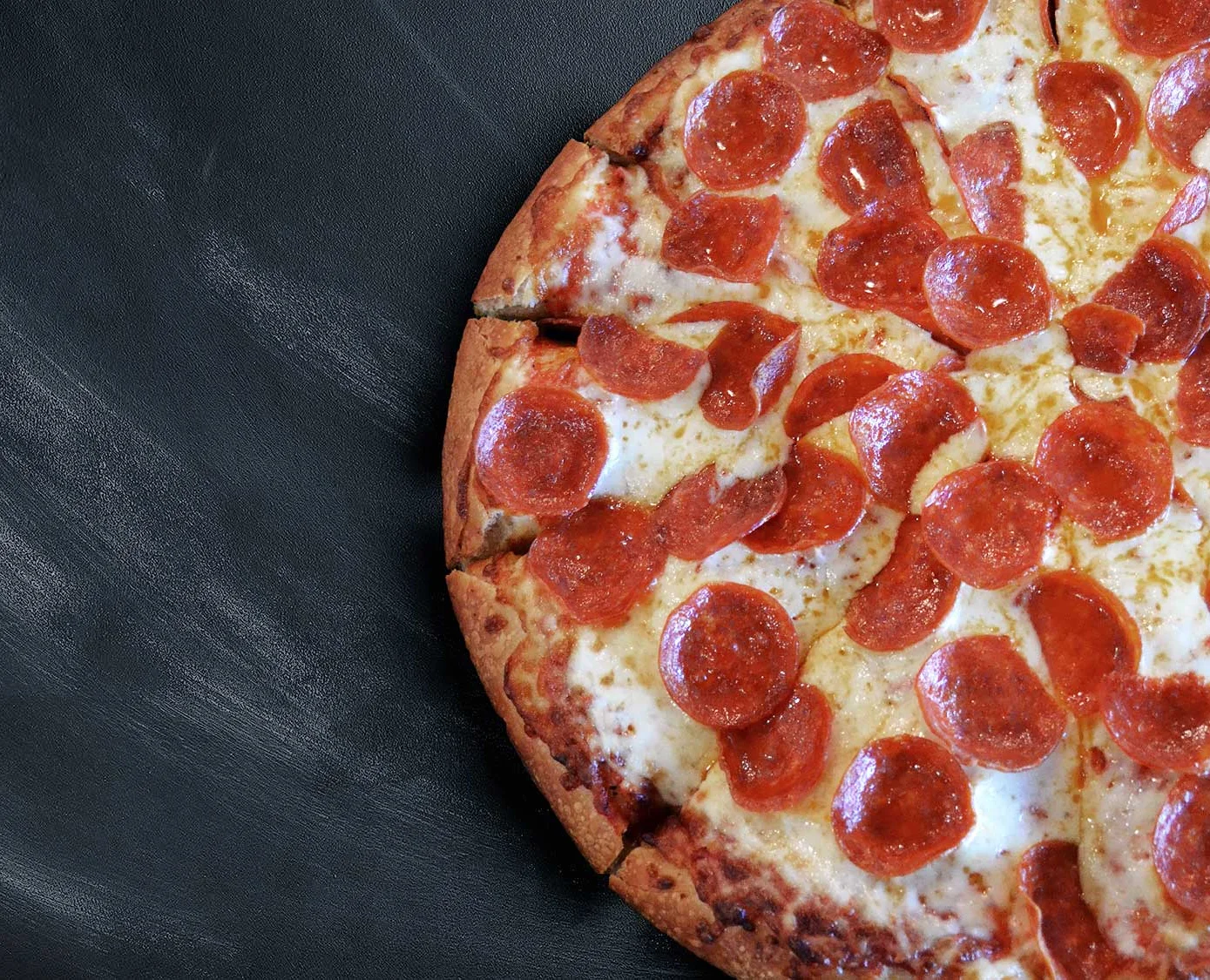 Classic pepperoni pizza on a black background