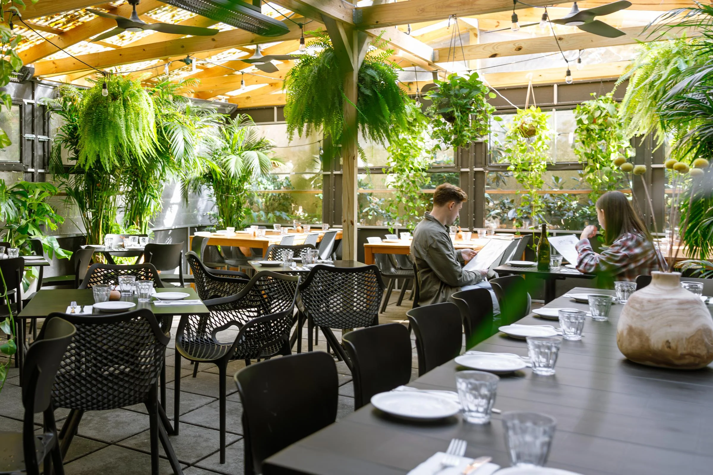 Stylish restaurant interior with greenery and modern decor