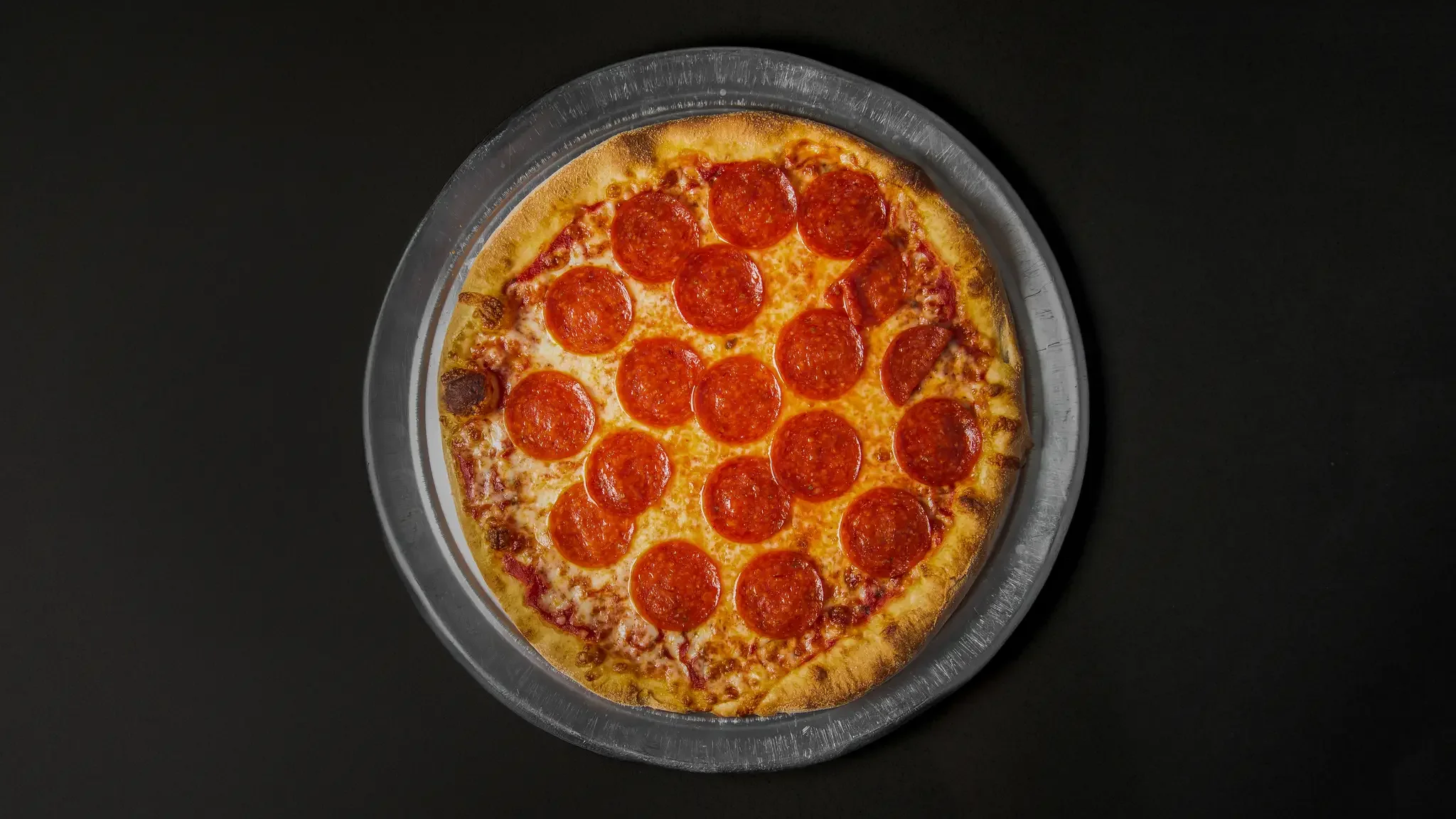 Classic pepperoni pizza on a metal tray