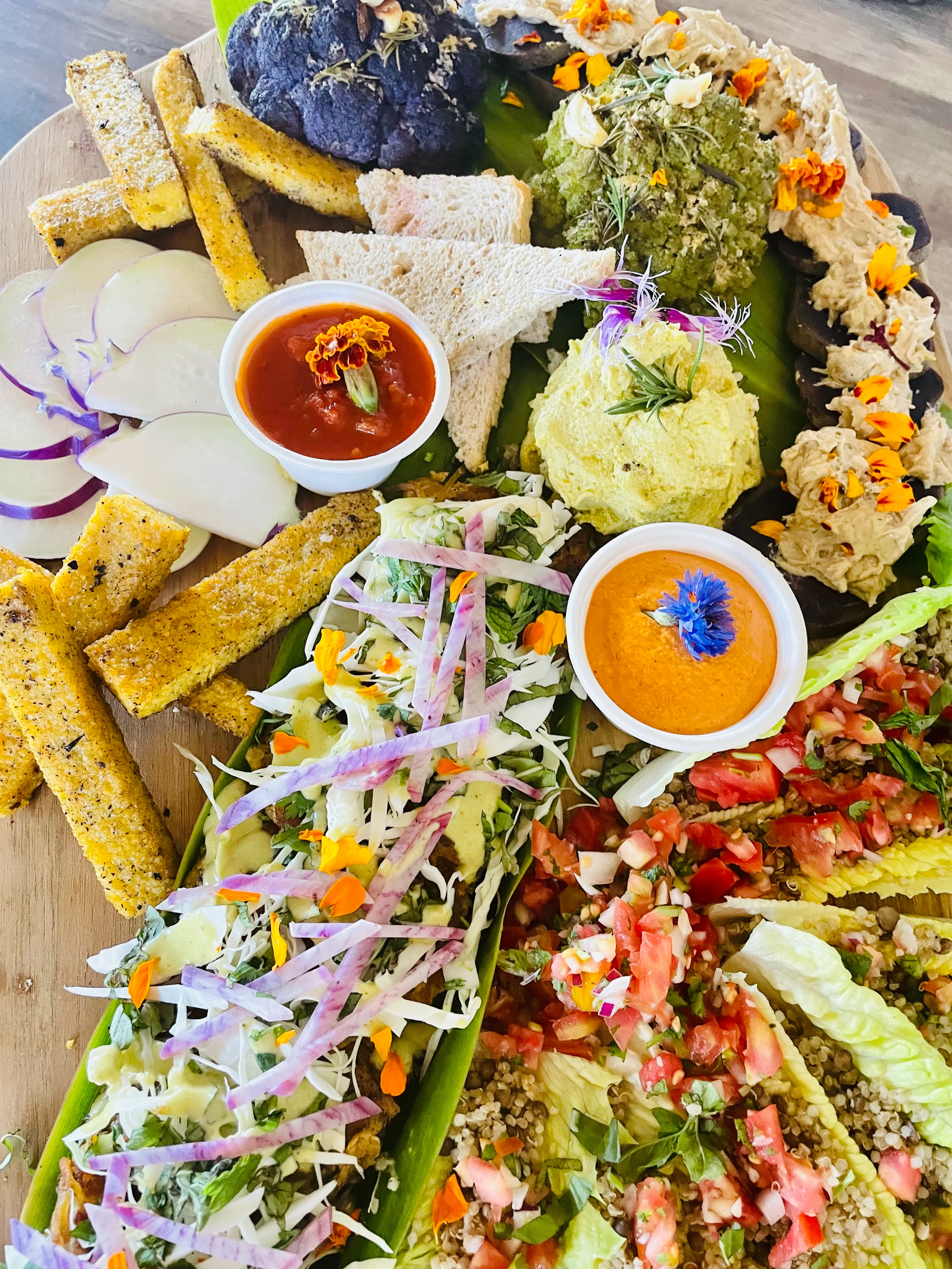 Colorful Mexican platter with various dips and fresh vegetables