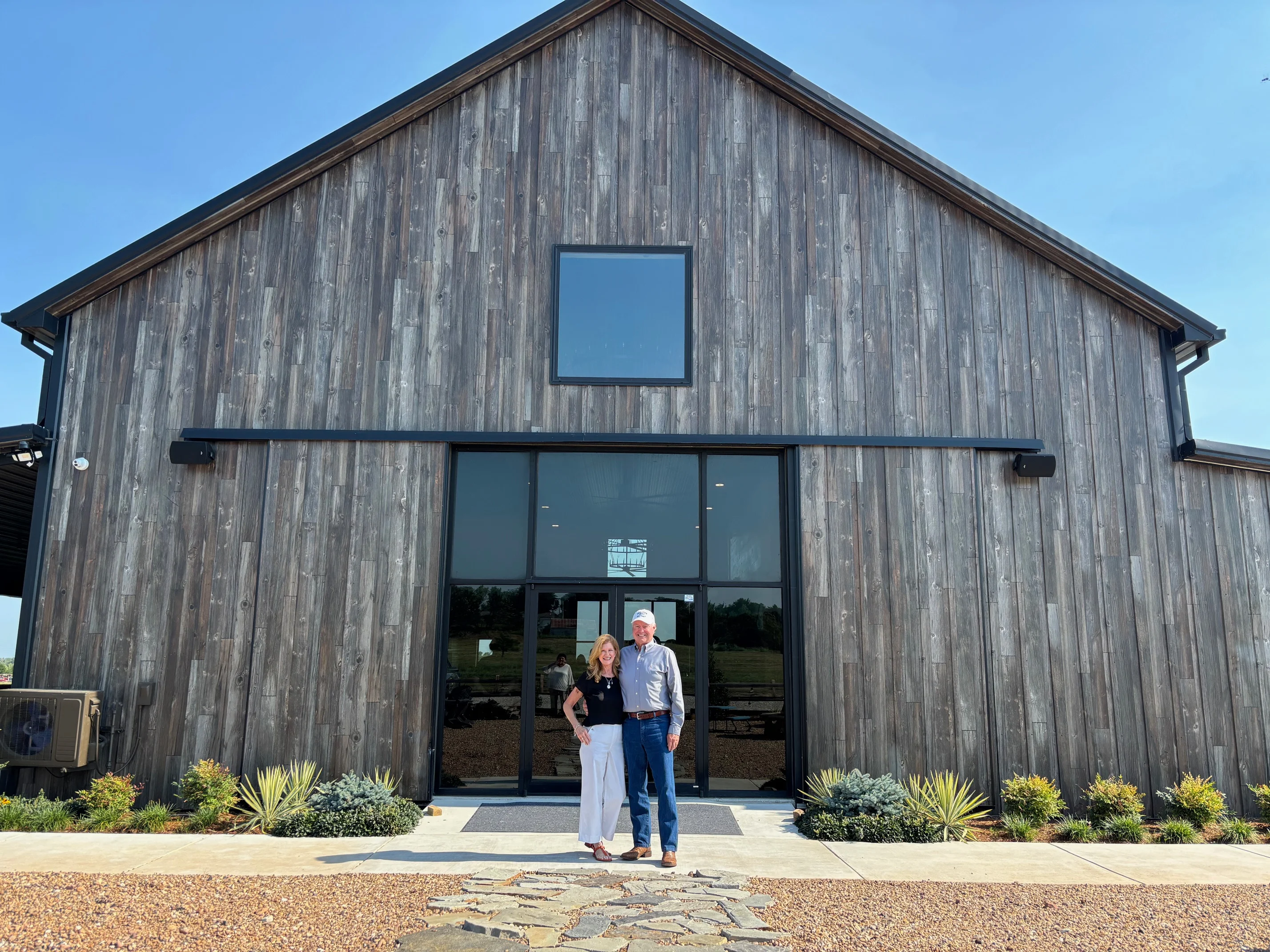 Modern barn-style restaurant exterior with landscaping
