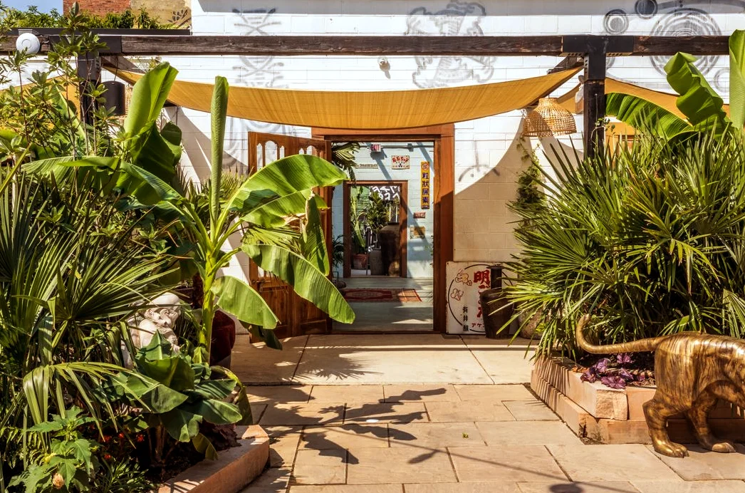 Charming restaurant entrance surrounded by lush greenery