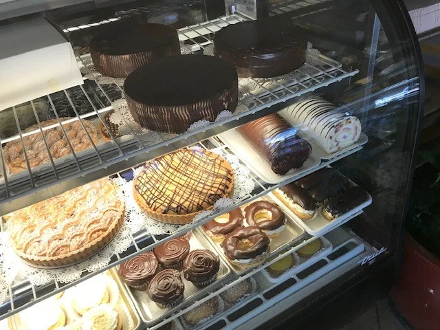 Cakes and tarts in the bakery display at The Kosher Pastry Oven