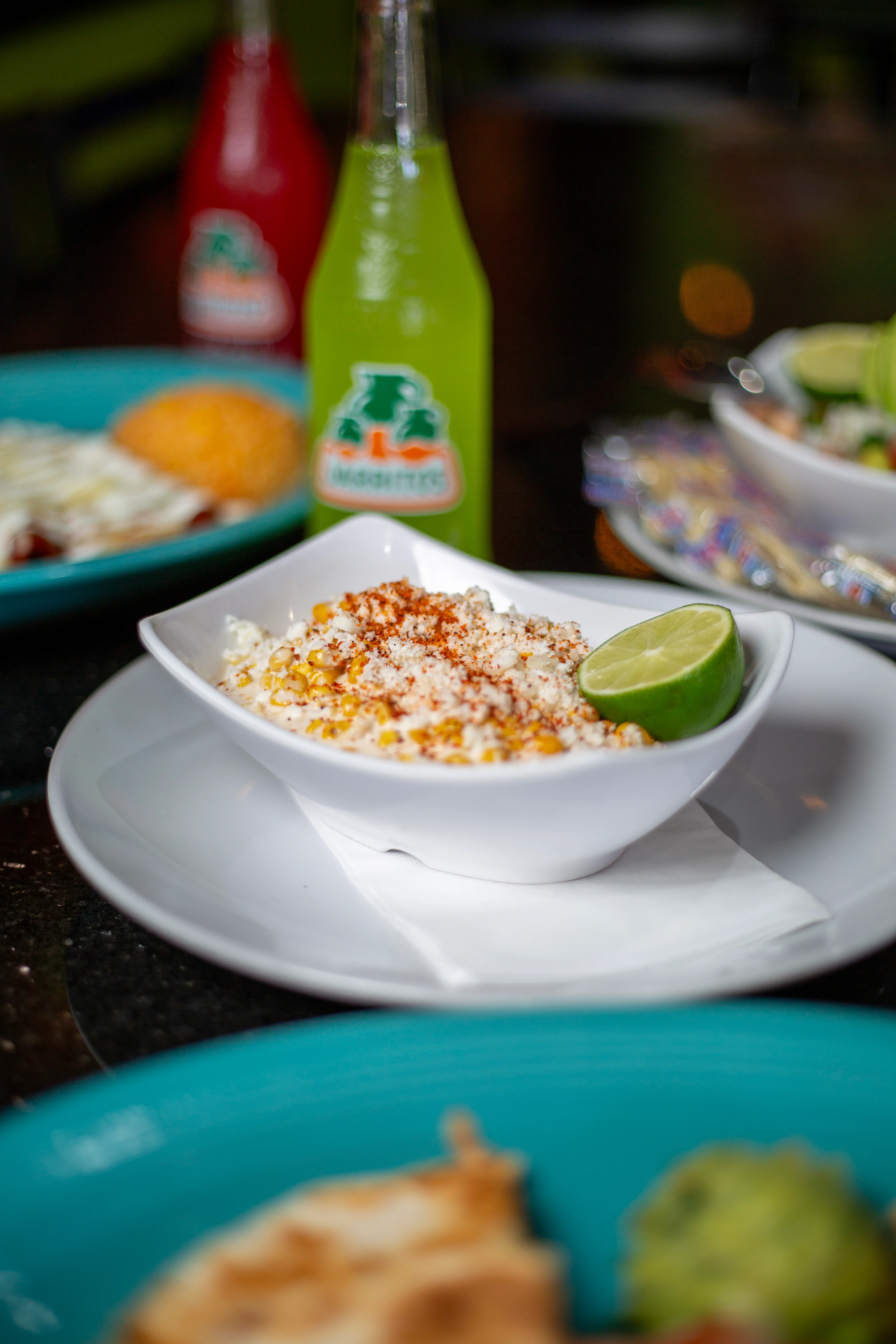 Mexican elote in a bowl with lime and spices