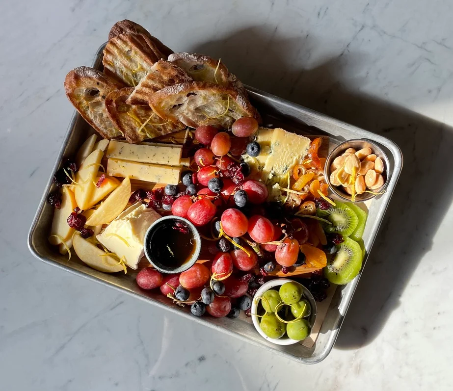 Artisan cheese and fruit platter with croissants