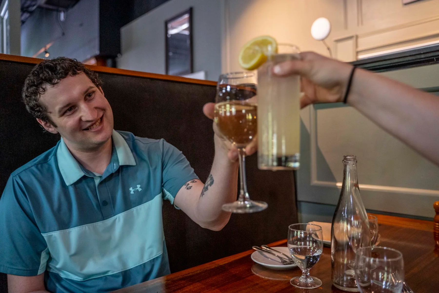 Cheers with cocktails in a cozy restaurant setting