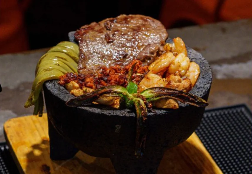 Sizzling Mexican fajitas served in a stone bowl