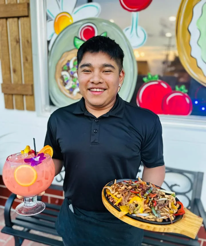 Colorful cocktails and sizzling fajitas served by a smiling waiter