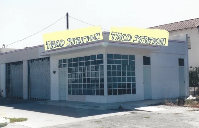 Exterior view of Taco Station restaurant with large signage