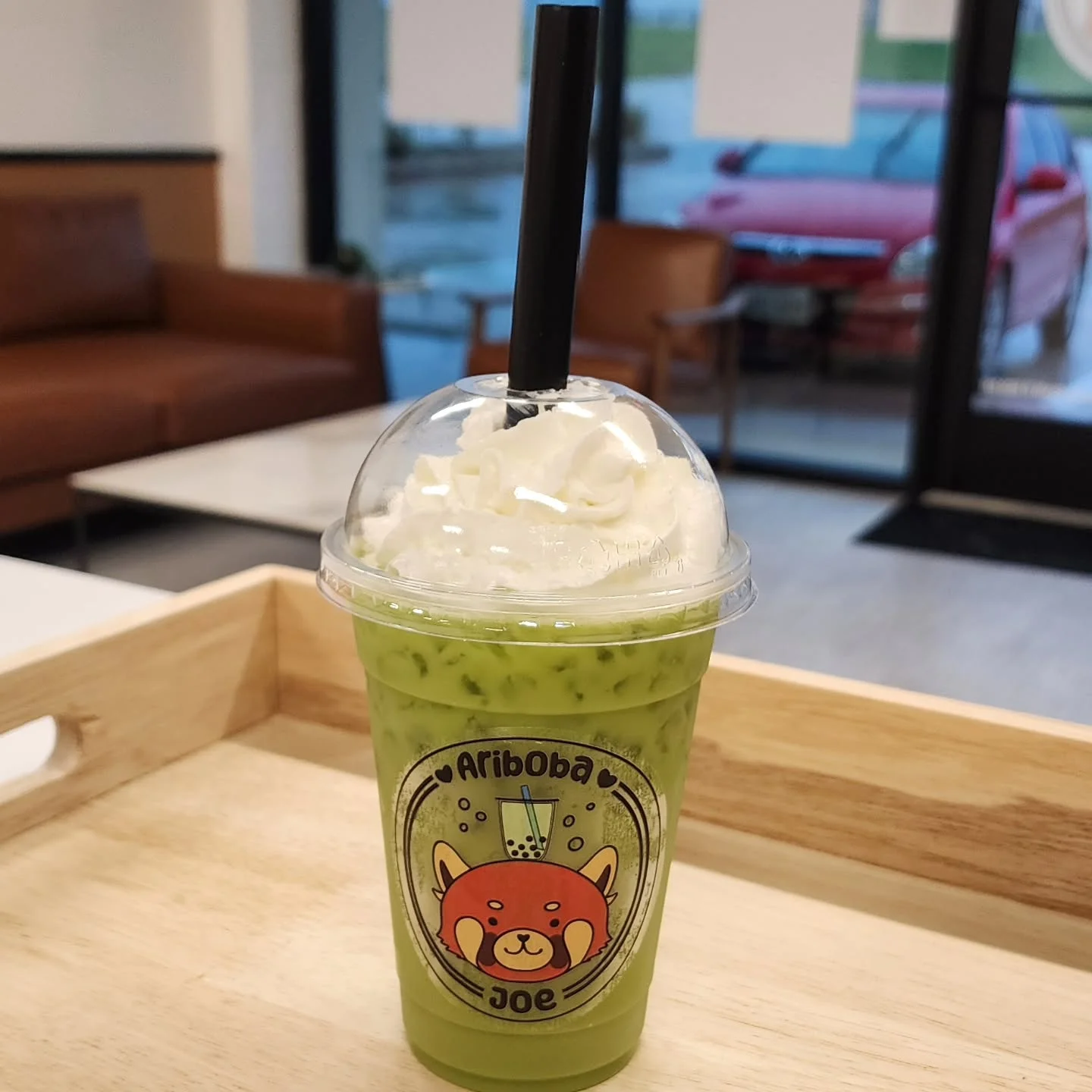 Iced matcha latte topped with whipped cream