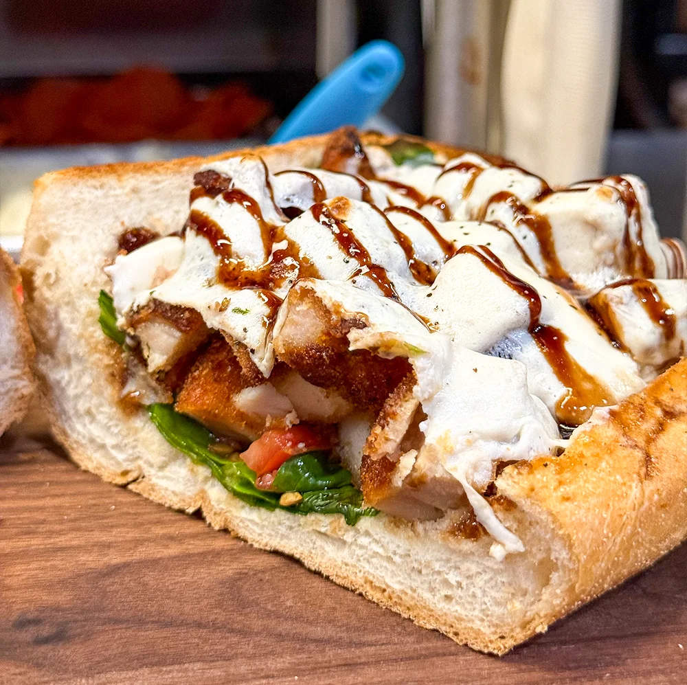  Caprese Cutlet stacks a crispy hand-breaded chicken cutlet with fresh mozzarella, ripe tomatoes, basil, and balsamic glaze on an Italian roll