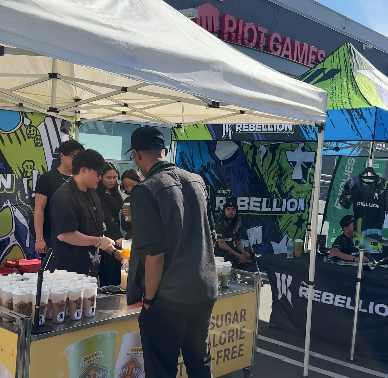 Outdoor event booth with drinks and promotional items
