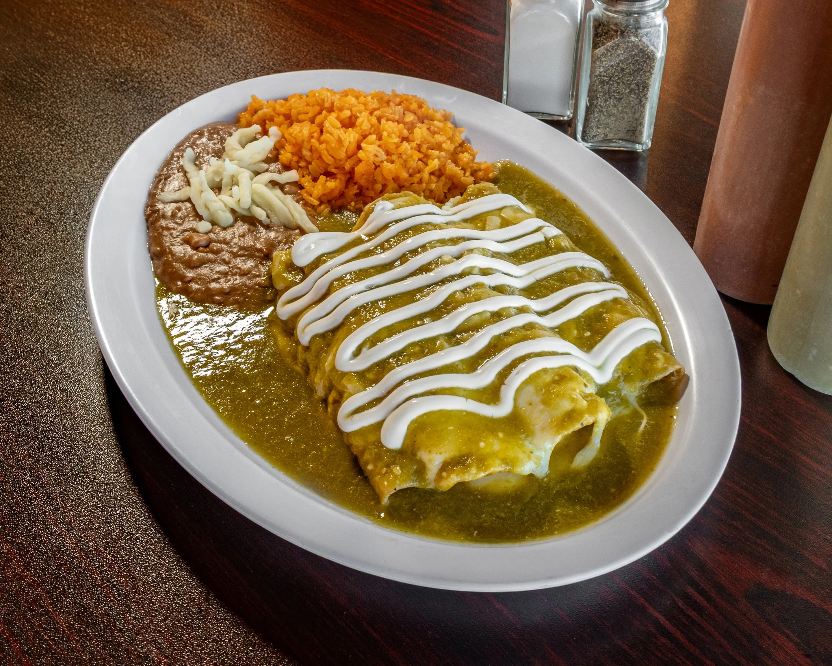 Delicious enchiladas topped with sauce and garnished with fresh ingredients.