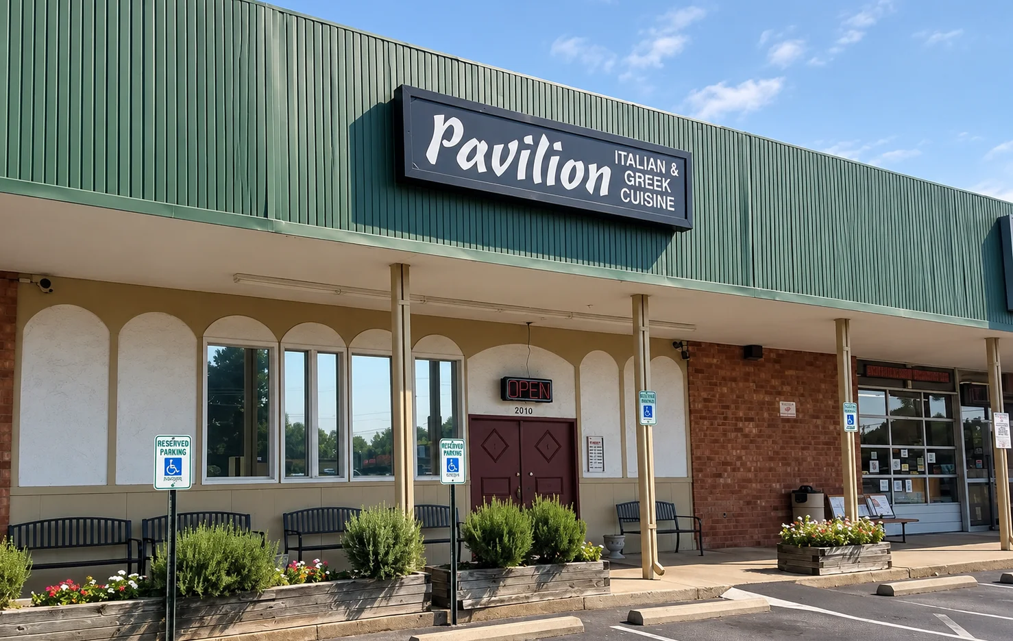 Pavilion Italian and Greek restaurant exterior with entrance and outdoor planters