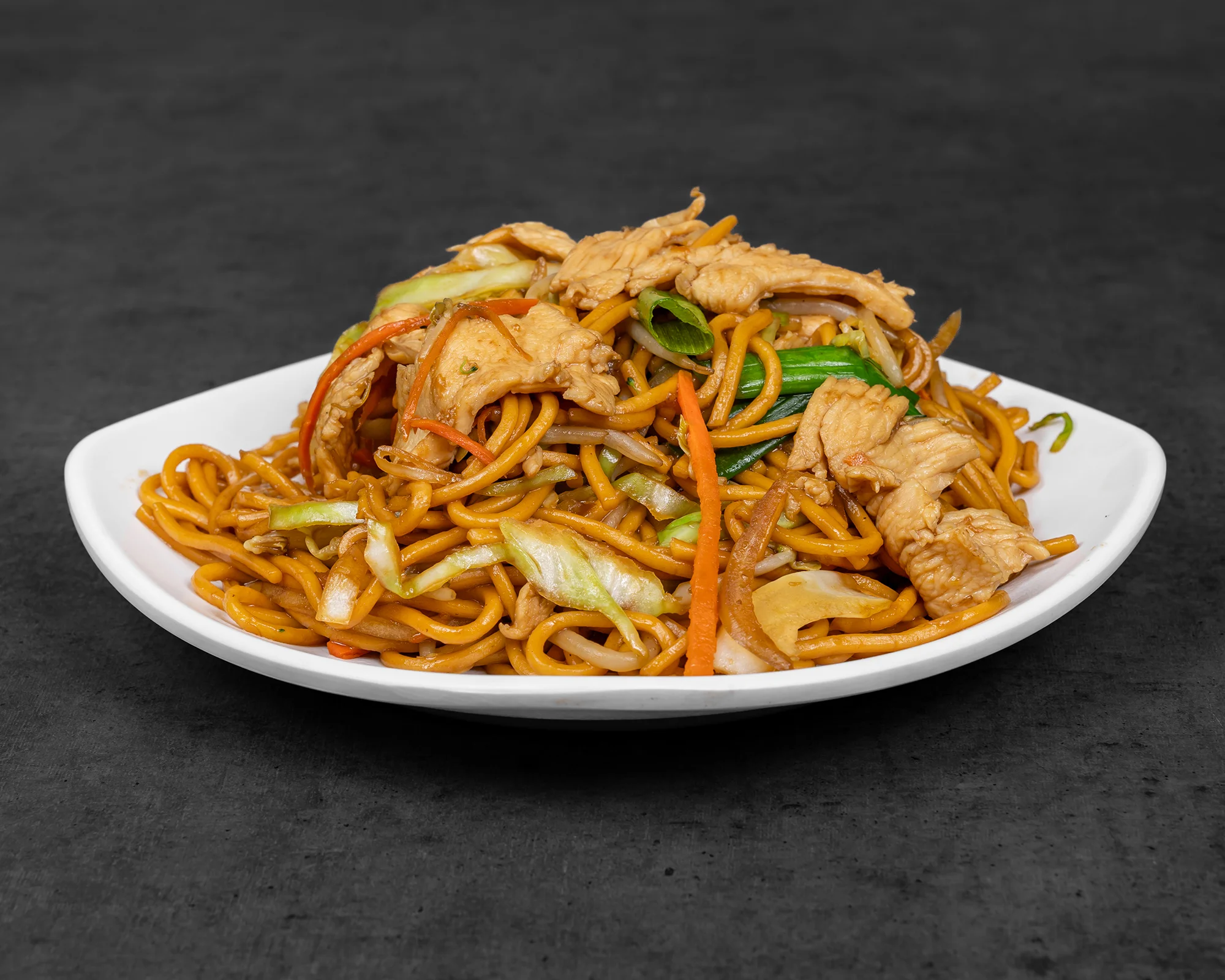 Delicious chicken chow mein served on a white plate