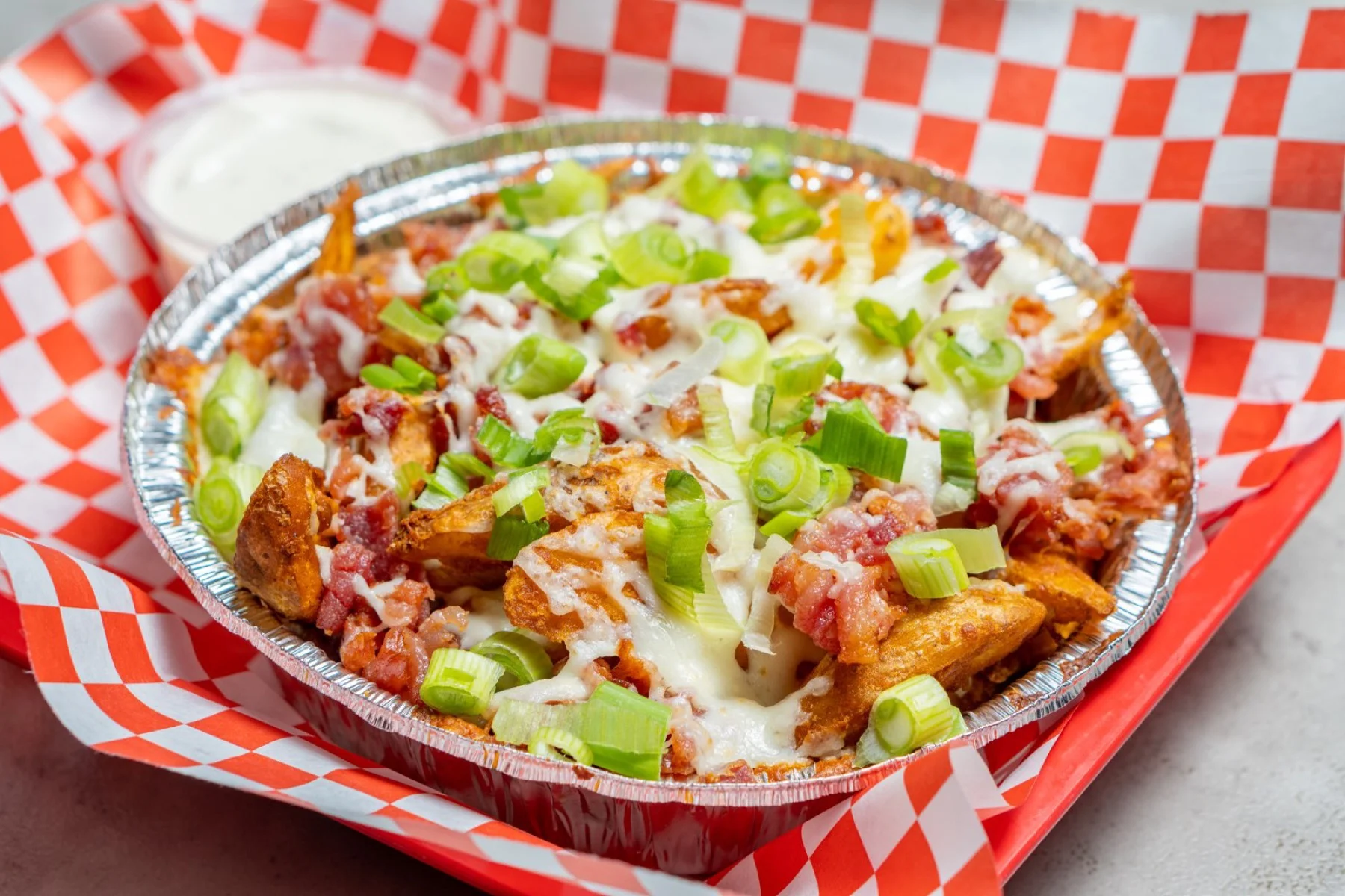 Loaded Pepz Potatoes with melted mozzarella, green onion and bacon bits