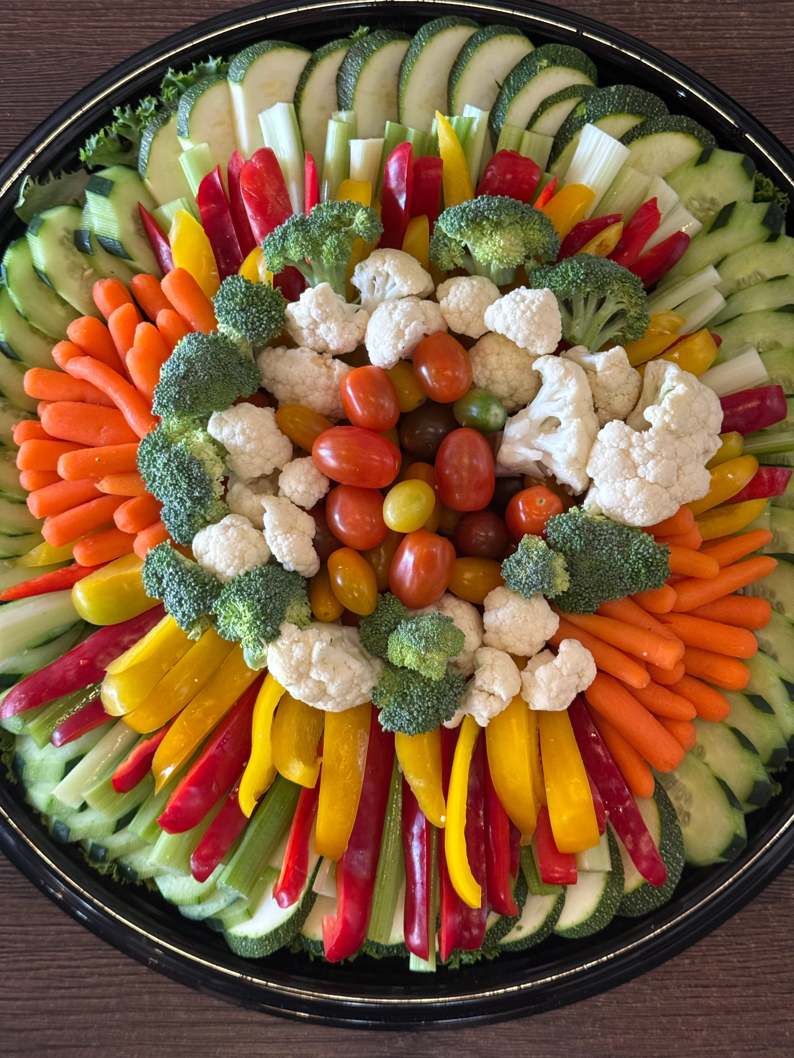 Colorful crudités platter arranged on a black serving tray