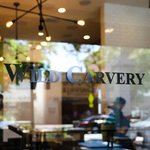 Restaurant window displaying 'Wild Carvery' sign
