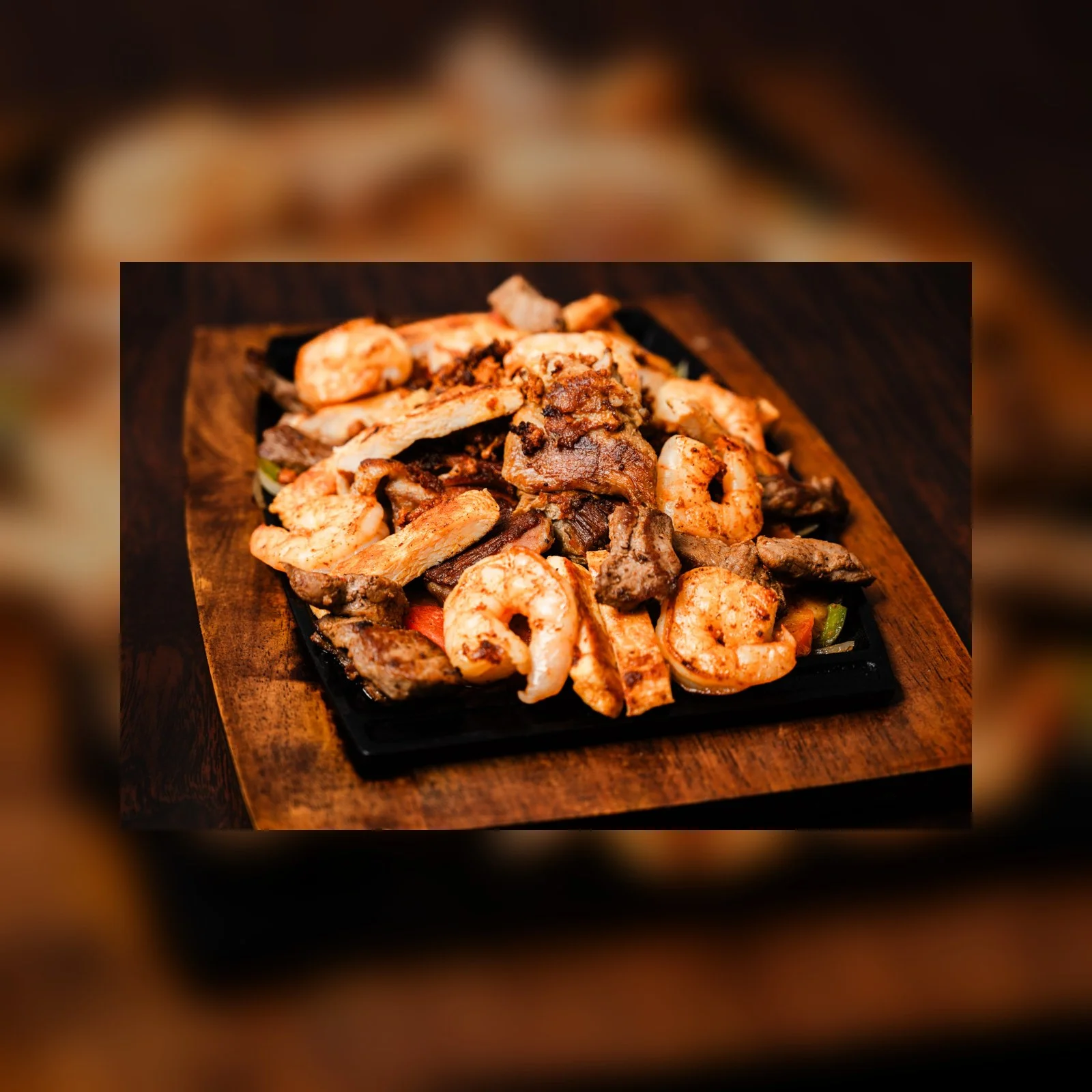 Sizzling mixed fajitas with shrimp and beef on a hot skillet