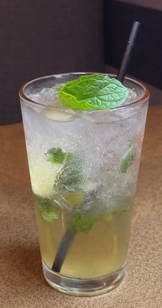 A refreshing mojito cocktail with mint and lime in a glass.
