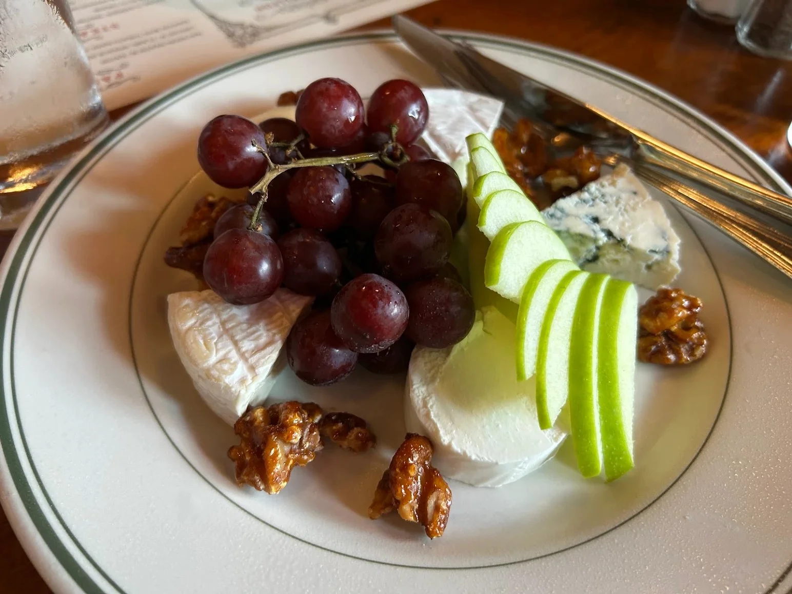 Artisan cheese platter with grapes and apple slices