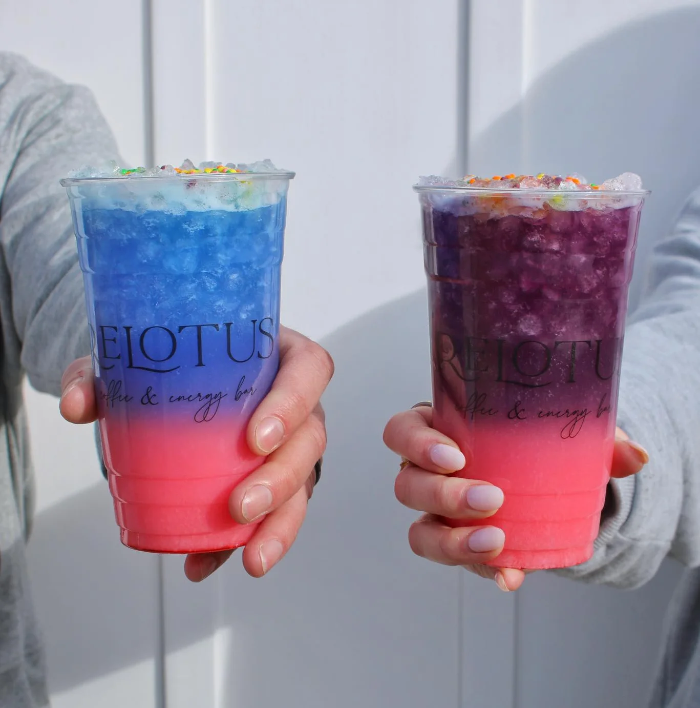 Colorful layered energy drinks in clear cups