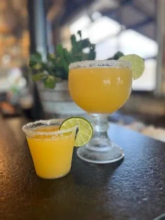 Refreshing margaritas served in glasses with lime garnish