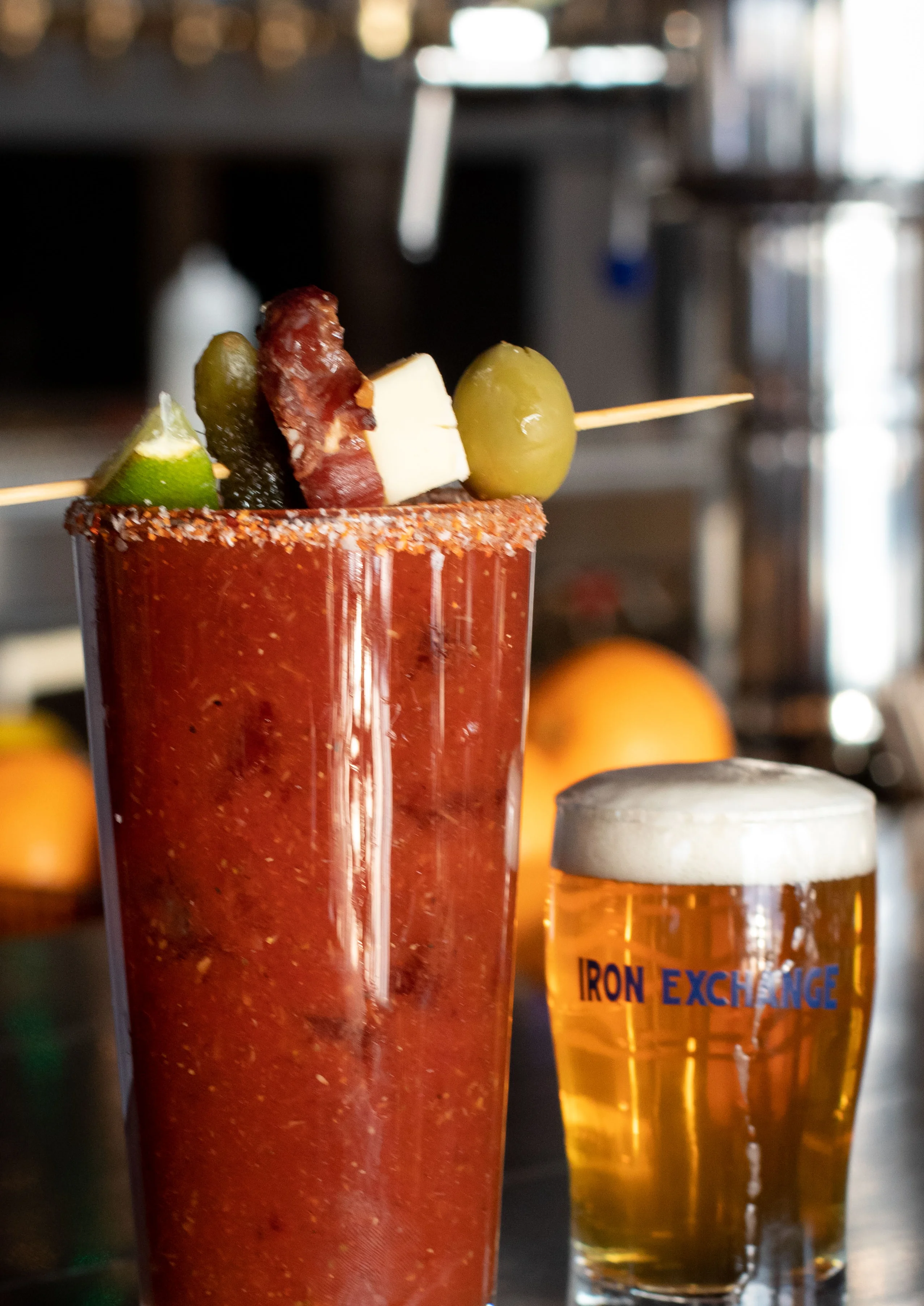 Bloody Mary cocktail with chili rim and colorful skewer garnish
