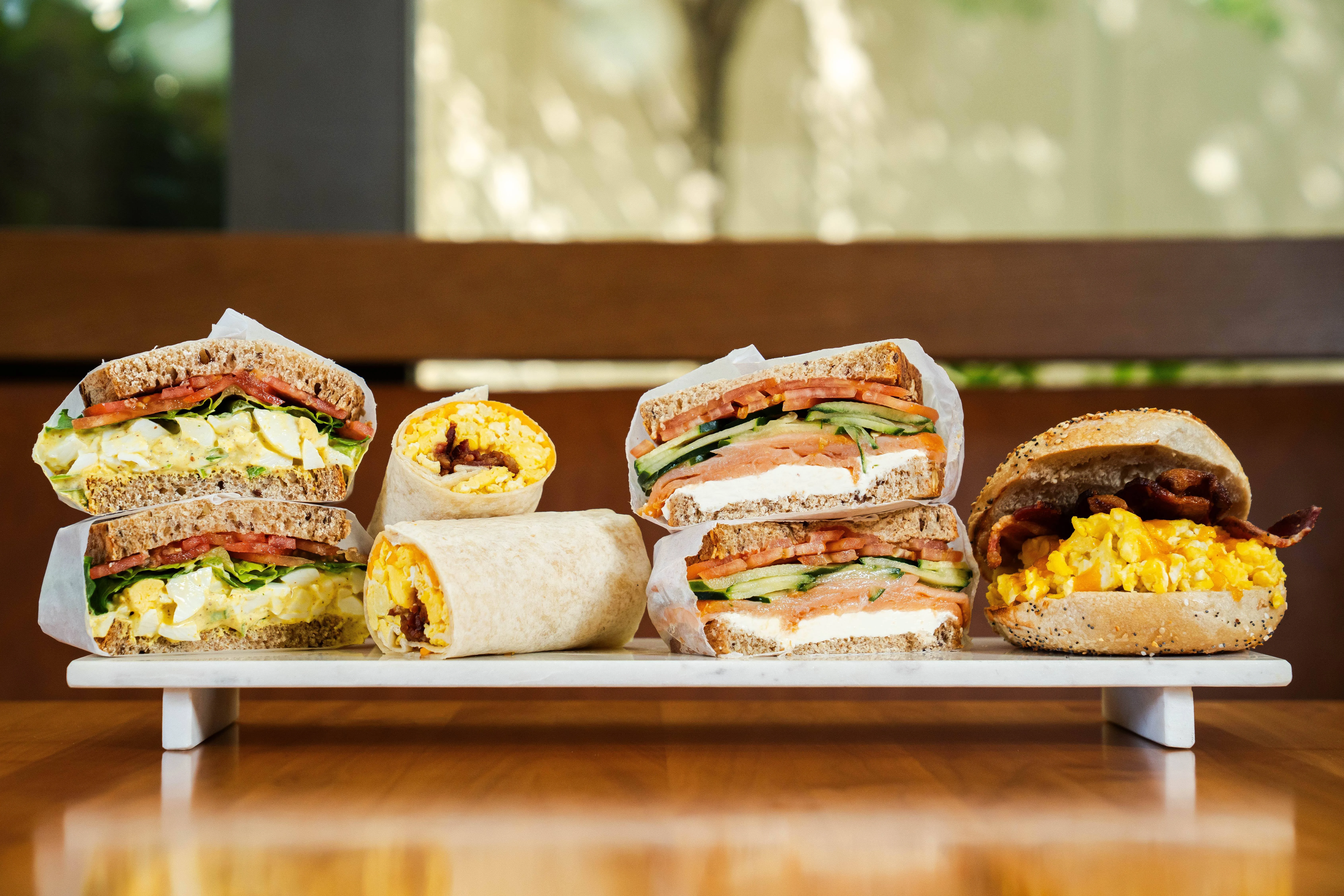 Delicious gourmet burger with fresh toppings on a wooden table