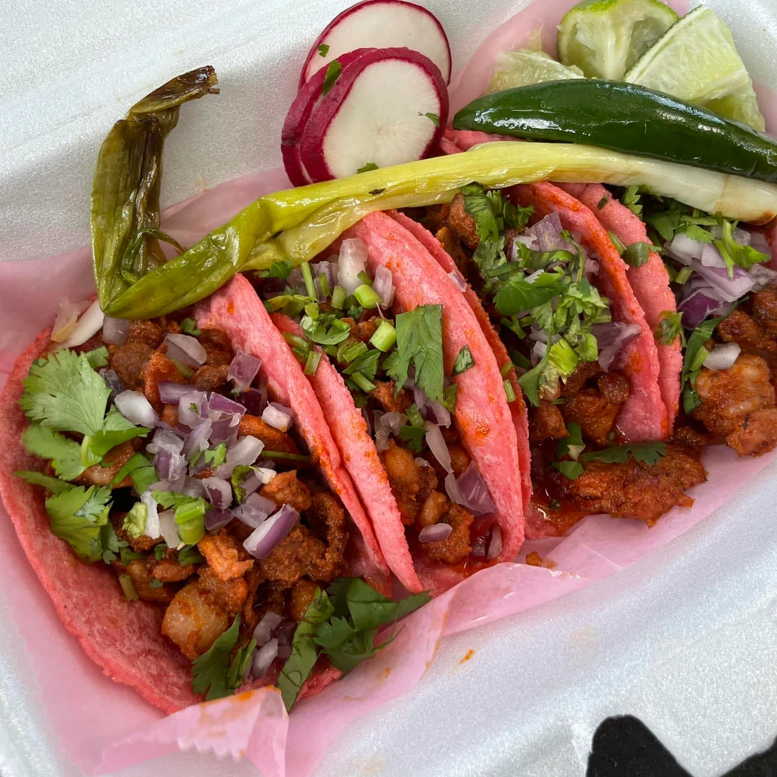 Colorful Mexican street tacos with vibrant pink tortillas