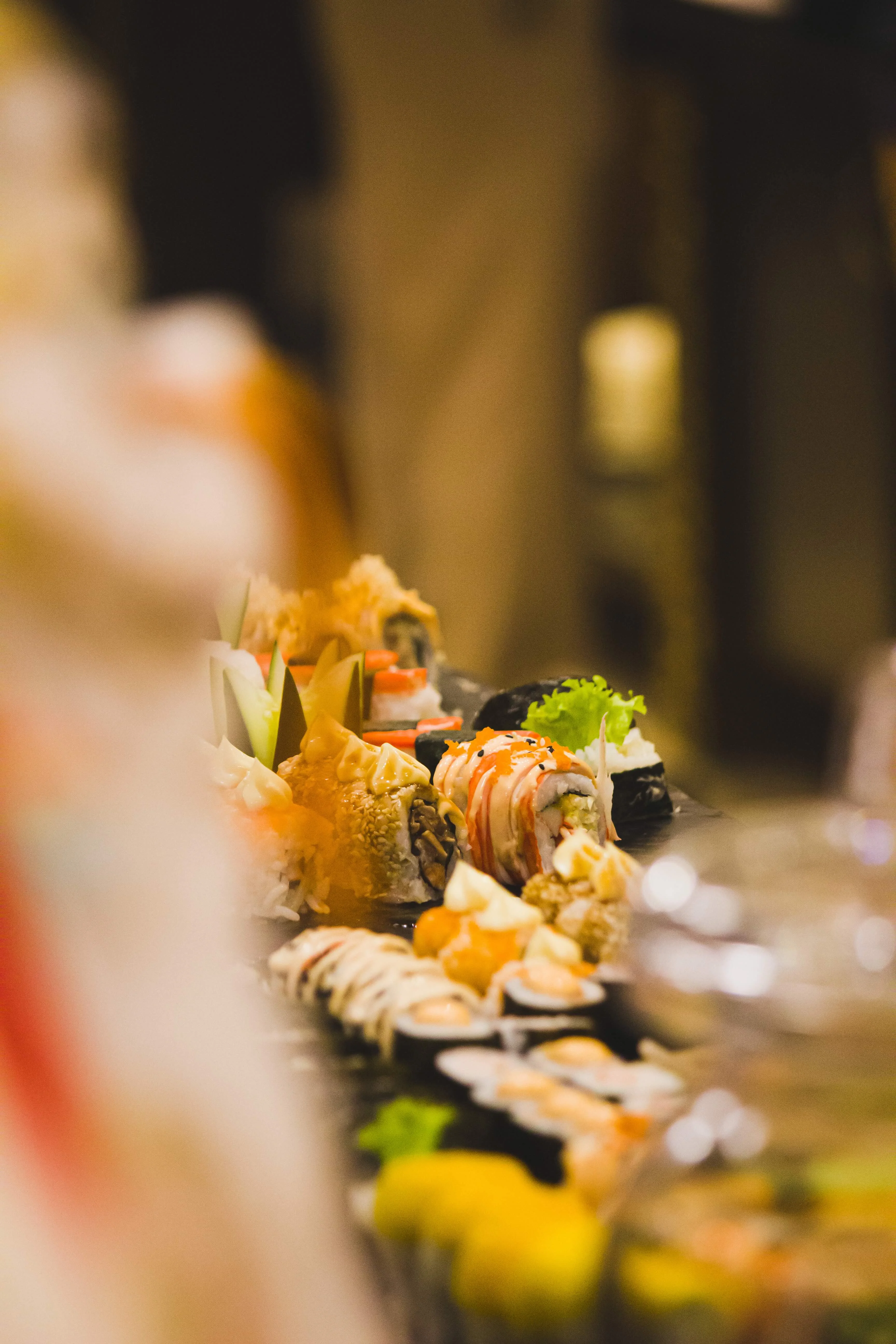Assorted sushi platter featuring various rolls and garnishes