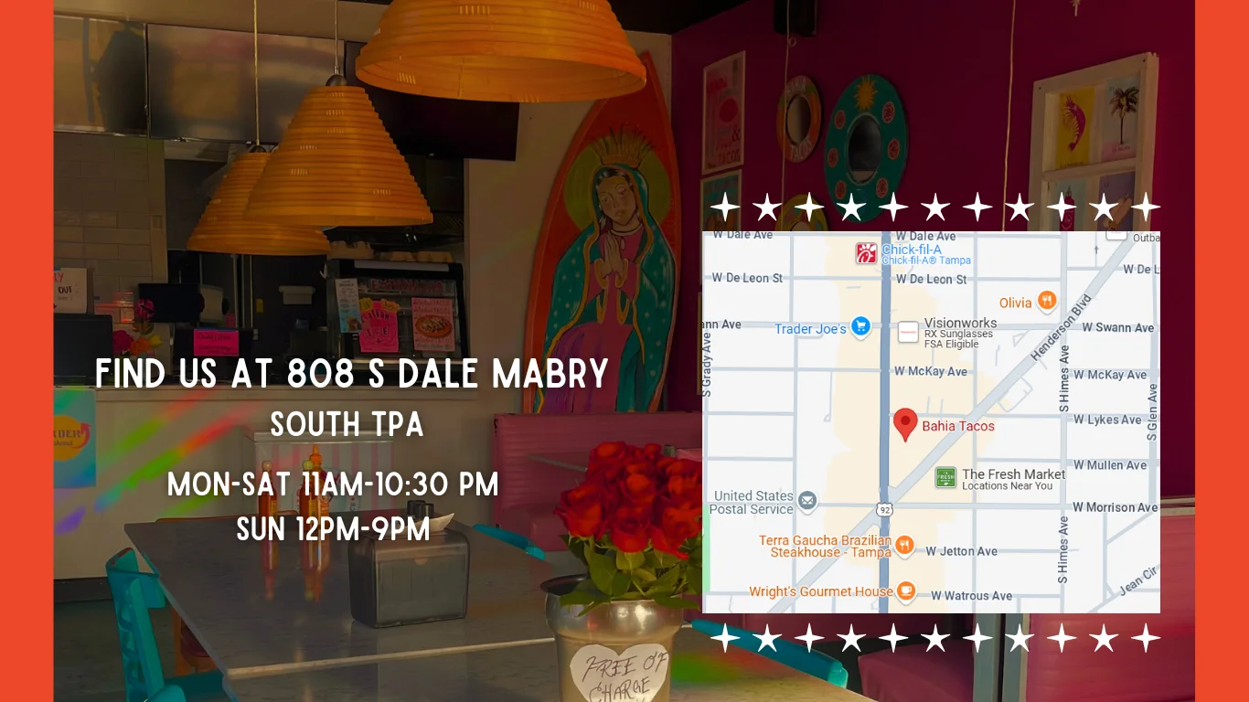 A colorful mexican restaurant with flowers on the table and art on the walls