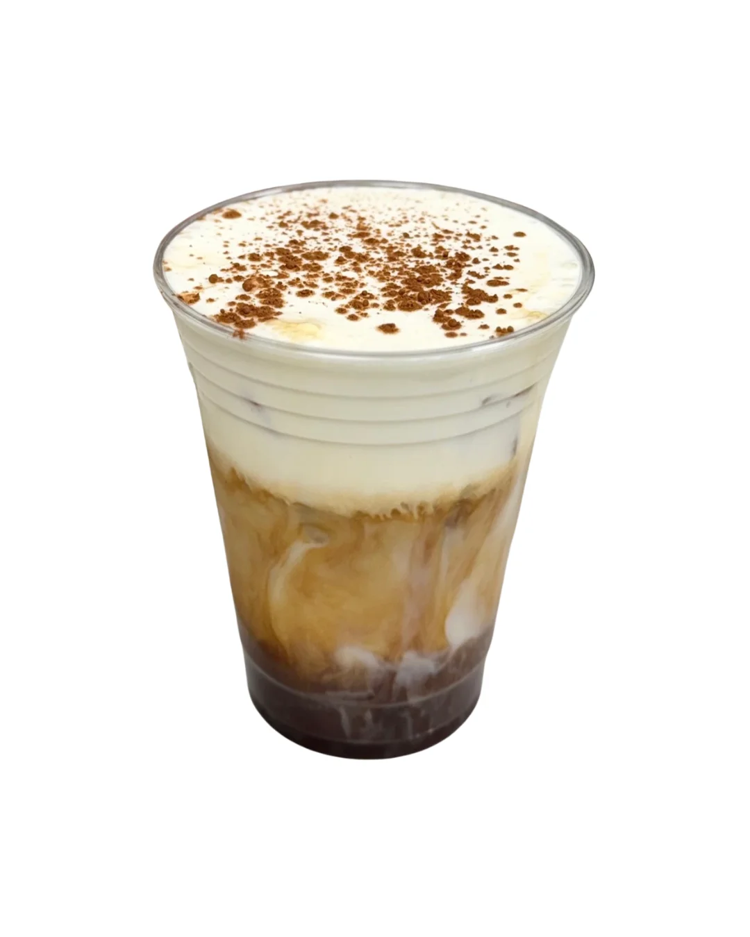 A transparent cup filled with layered iced coffee topped with whipped cream and sprinkled with cocoa powder.