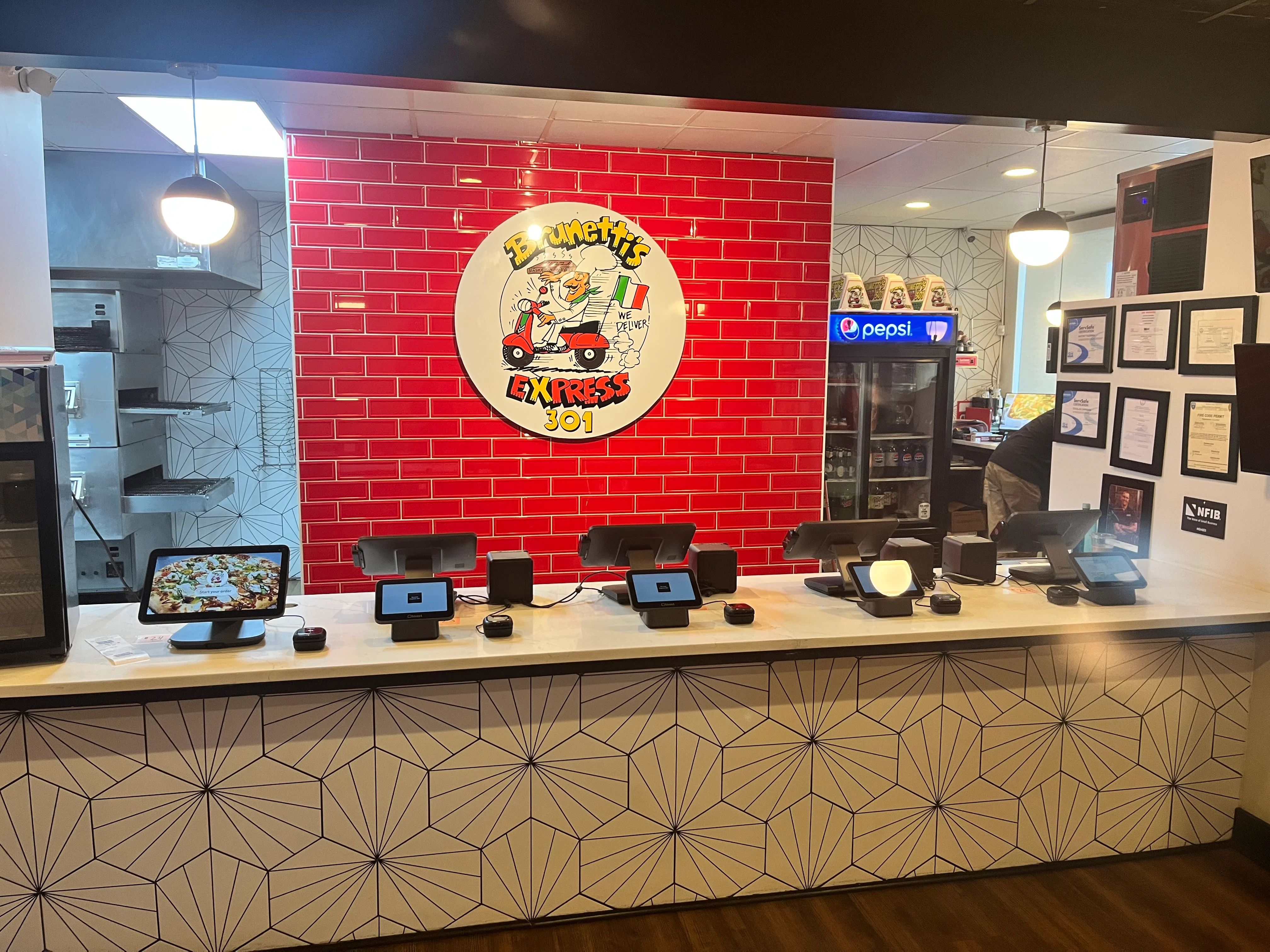 Modern restaurant counter with vibrant decor and digital ordering systems