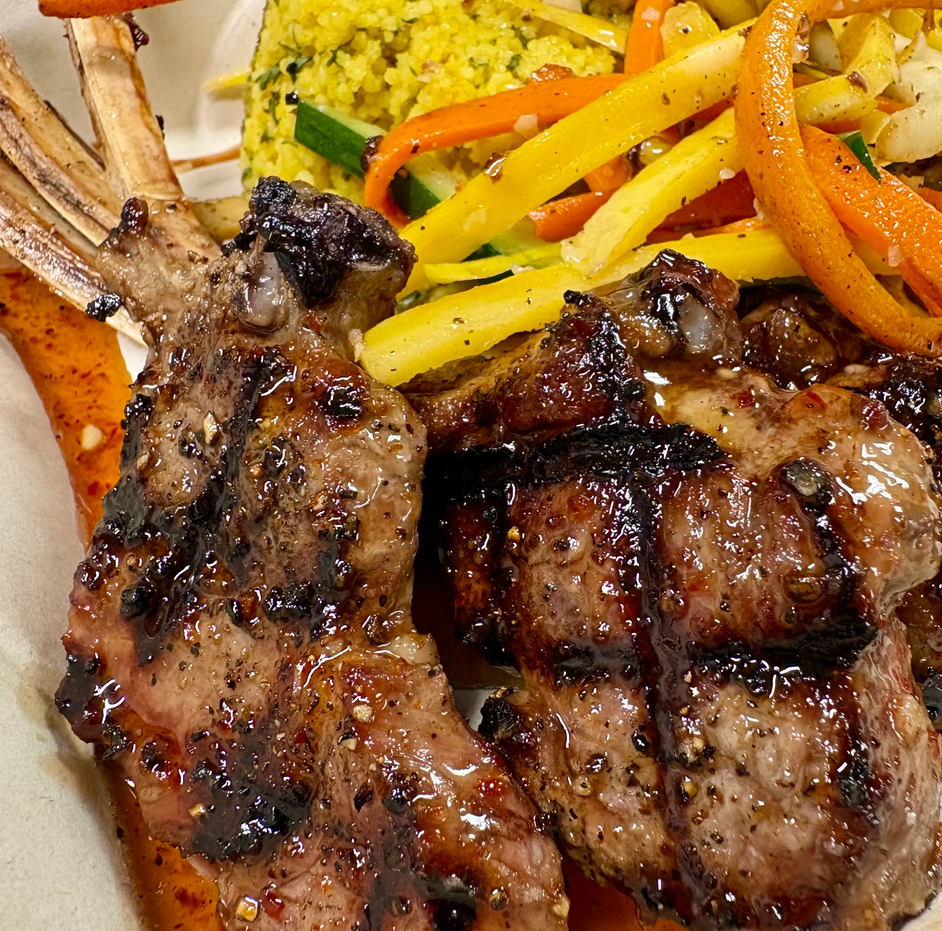 Delicious harissa lamb dish garnished with herbs and spices.