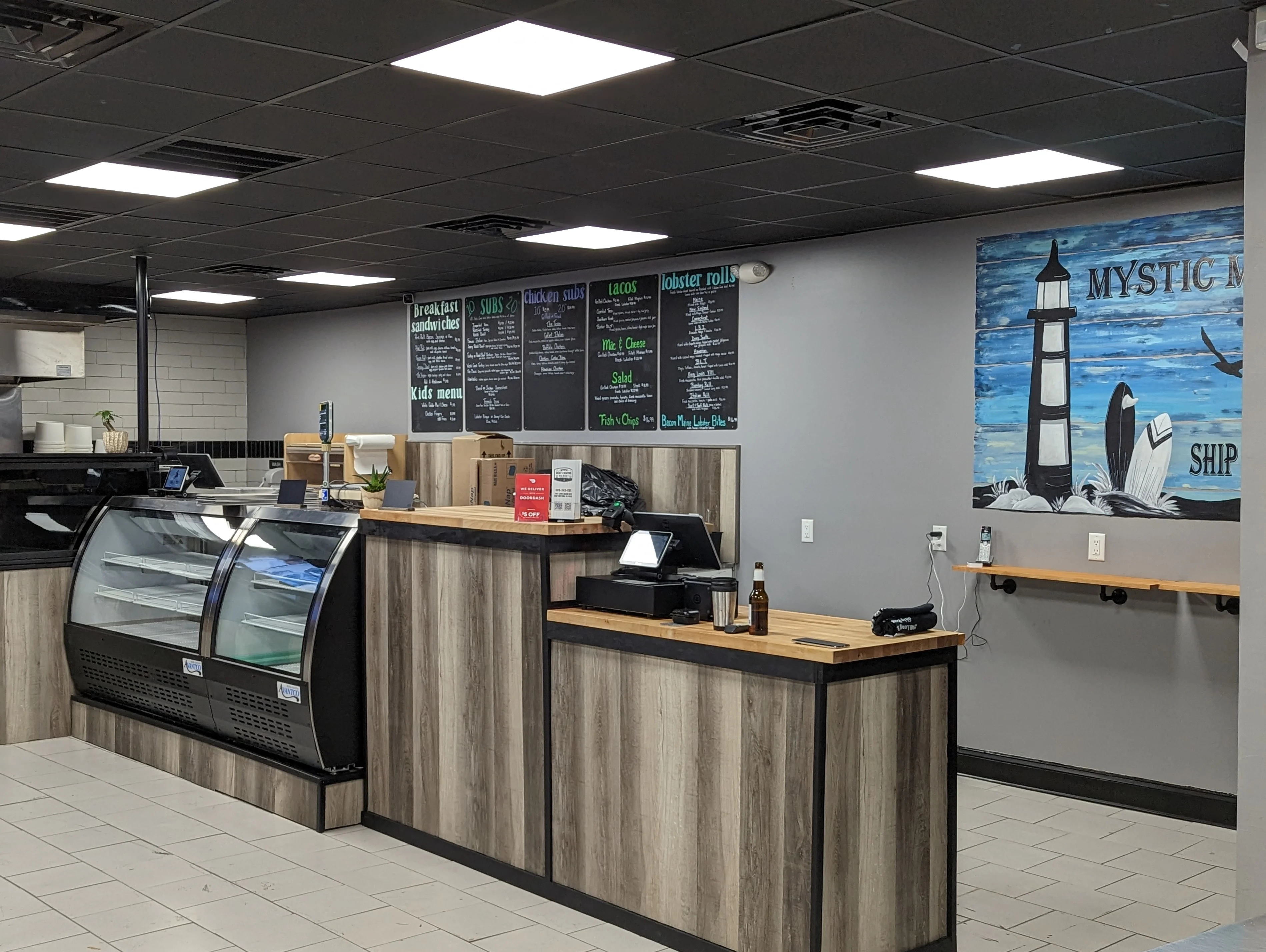 Modern restaurant interior with a counter and menu boards