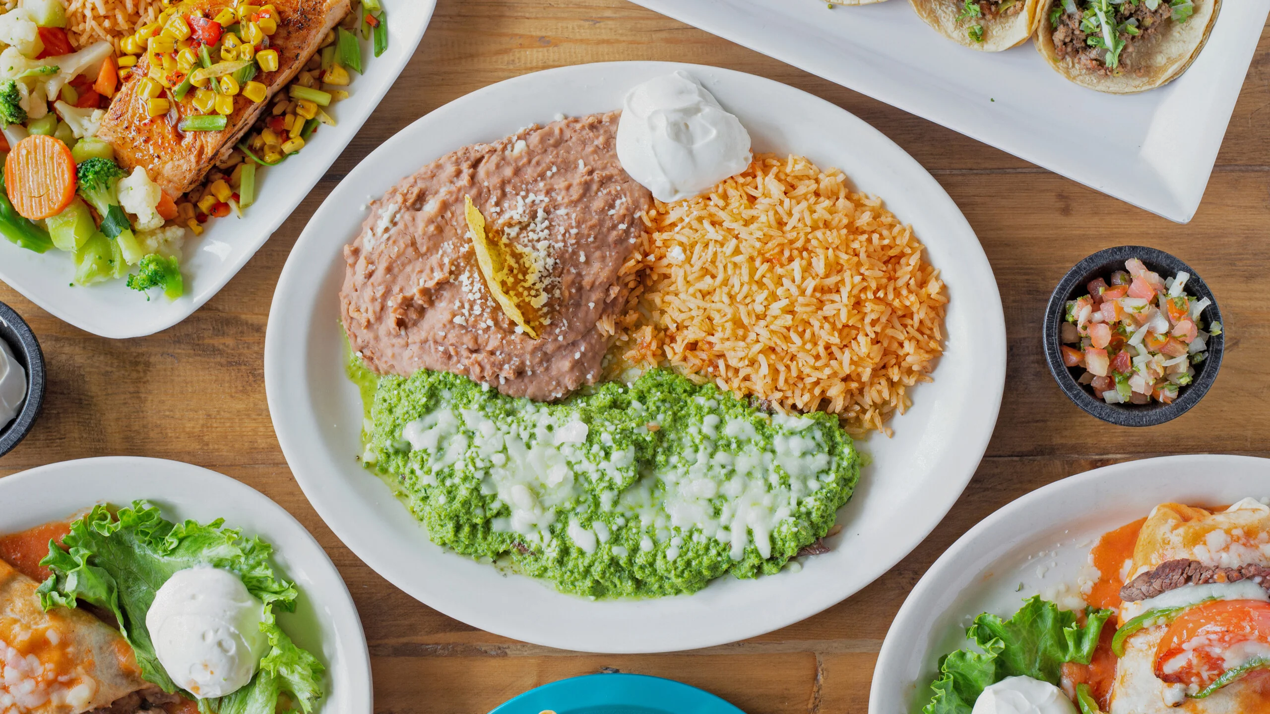 Plate of Mexican enchiladas with rice and beans