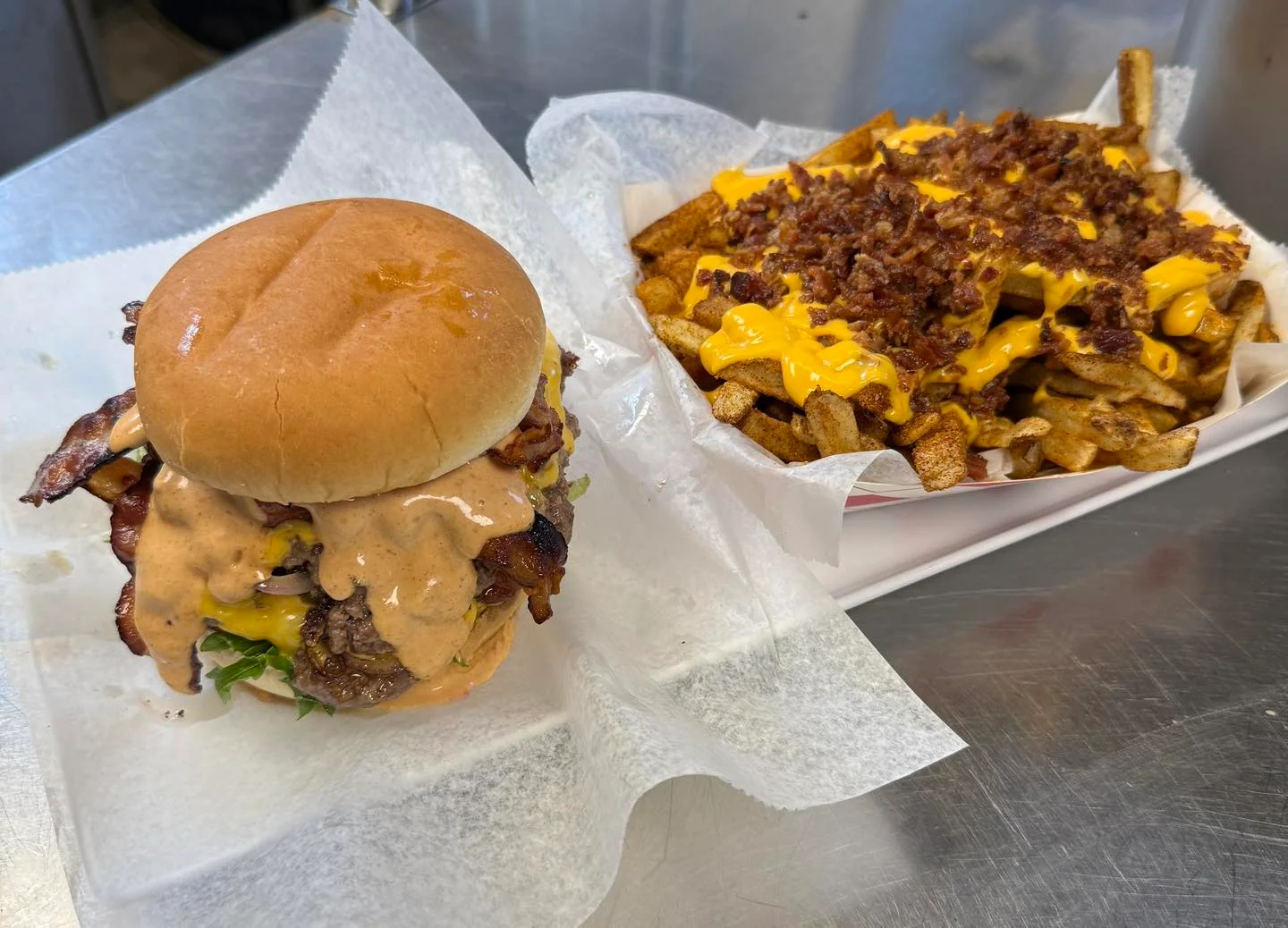 Juicy cheeseburger with bacon and loaded cheese fries