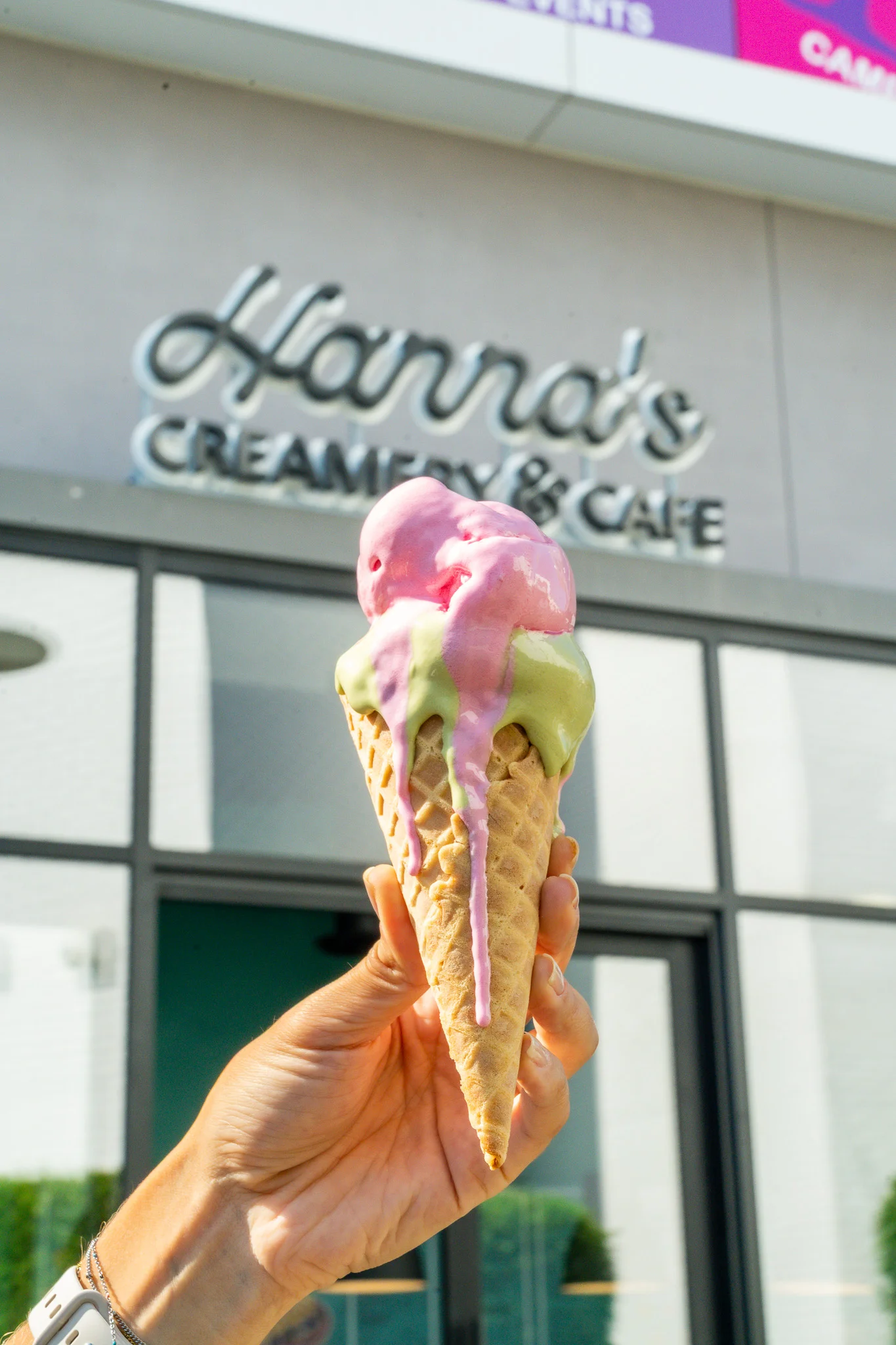 Colorful ice cream cone with pink and green scoops