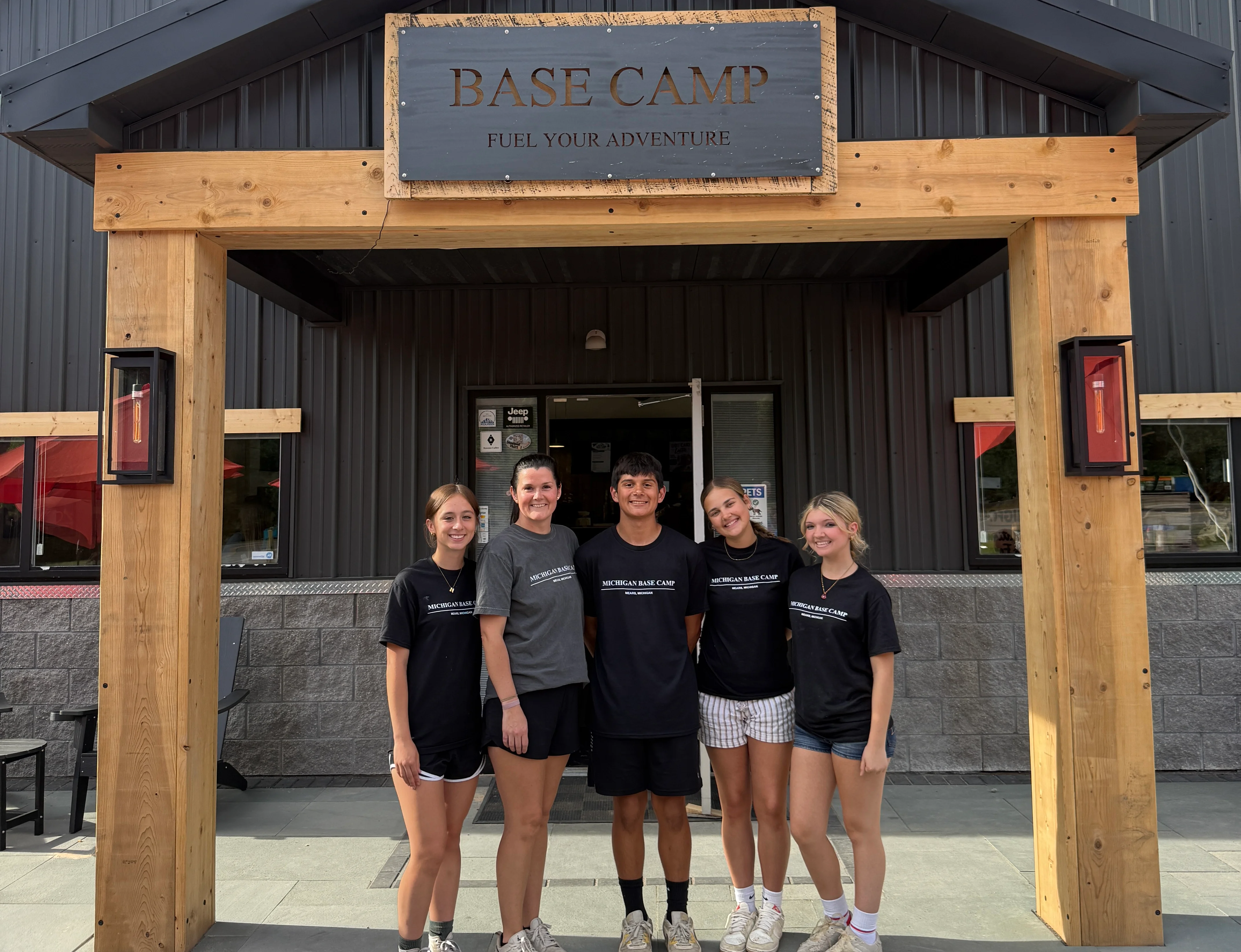 Staff in front of Base Camp restaurant, ready to serve customers