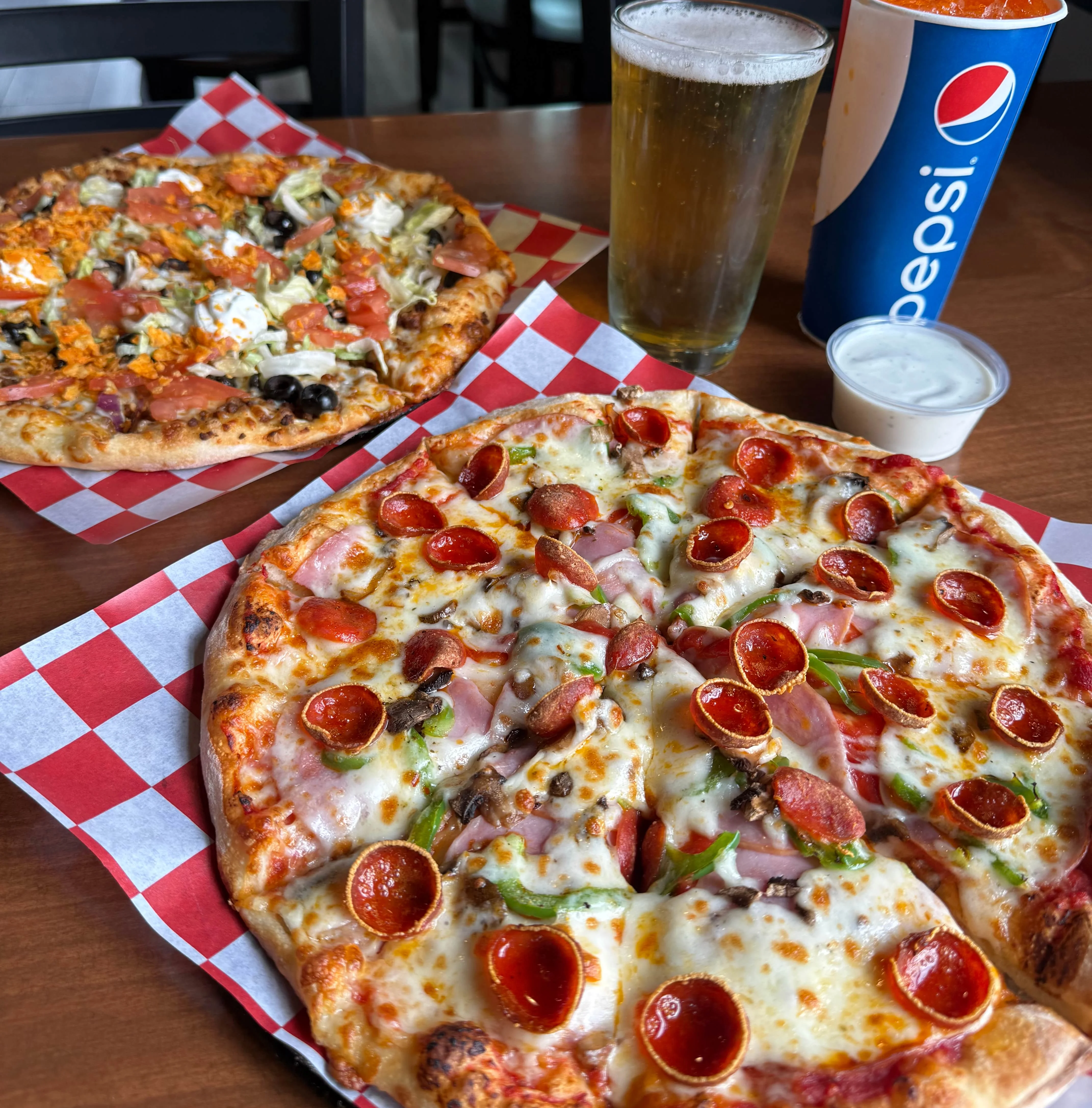Pepperoni pizza and loaded nachos in a casual dining setting