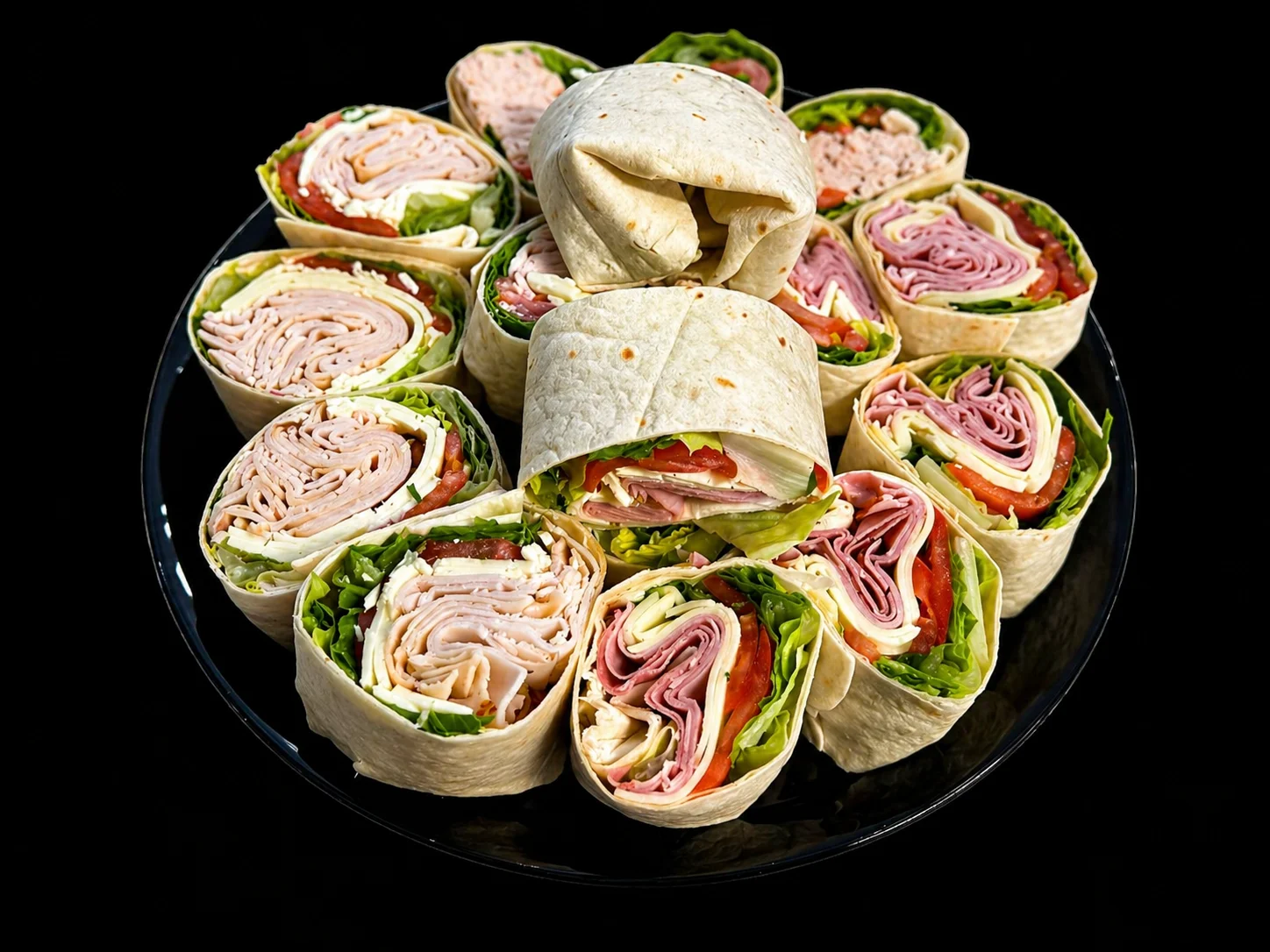 Assorted deli wraps on a black platter
