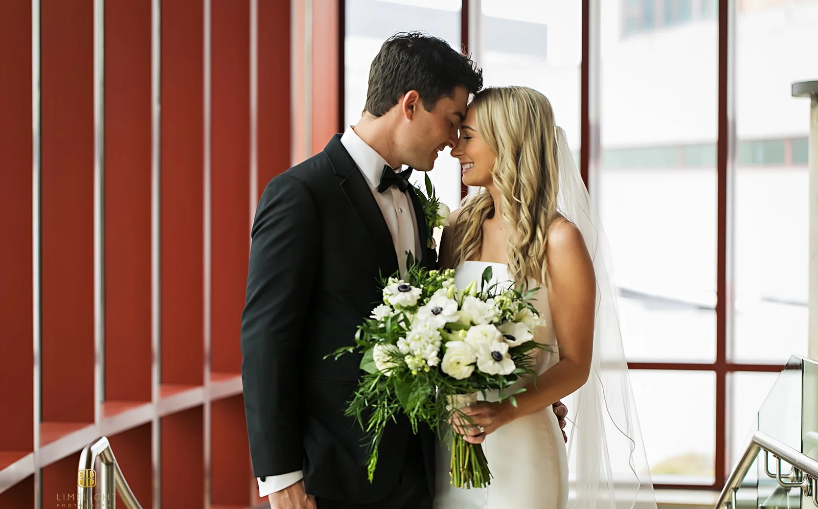 Bride and groom sharing a romantic moment indoors