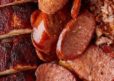 Platter of Texas-style barbecue with tacos and sides