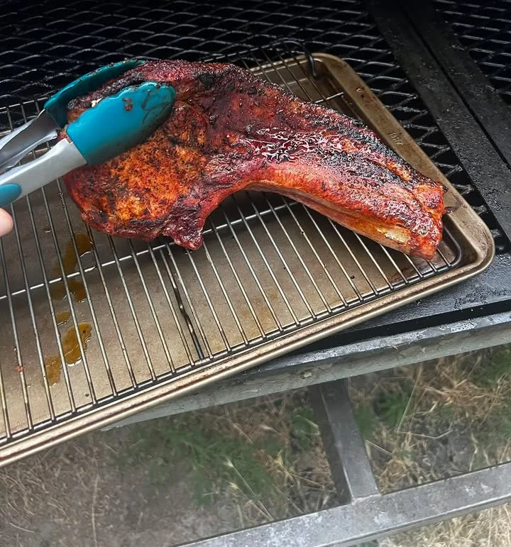 Smoked beef brisket resting on a rack