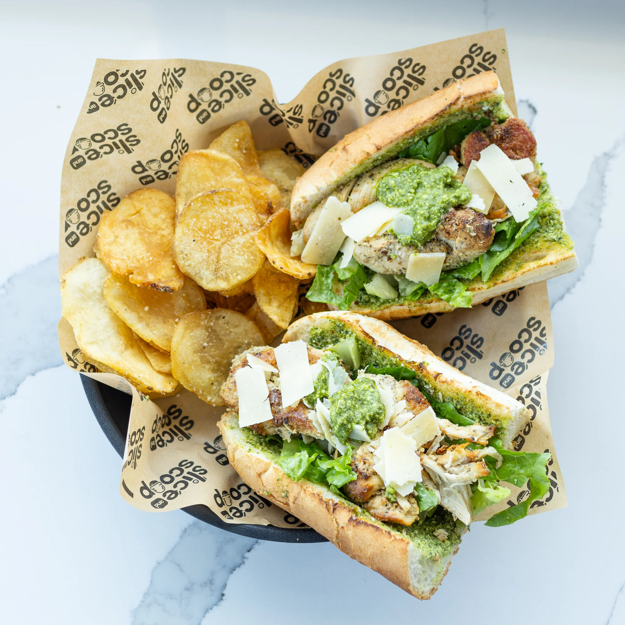 A caesar salad sandwich with chips