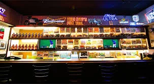 Vibrant bar counter with neon lights and beverage displays